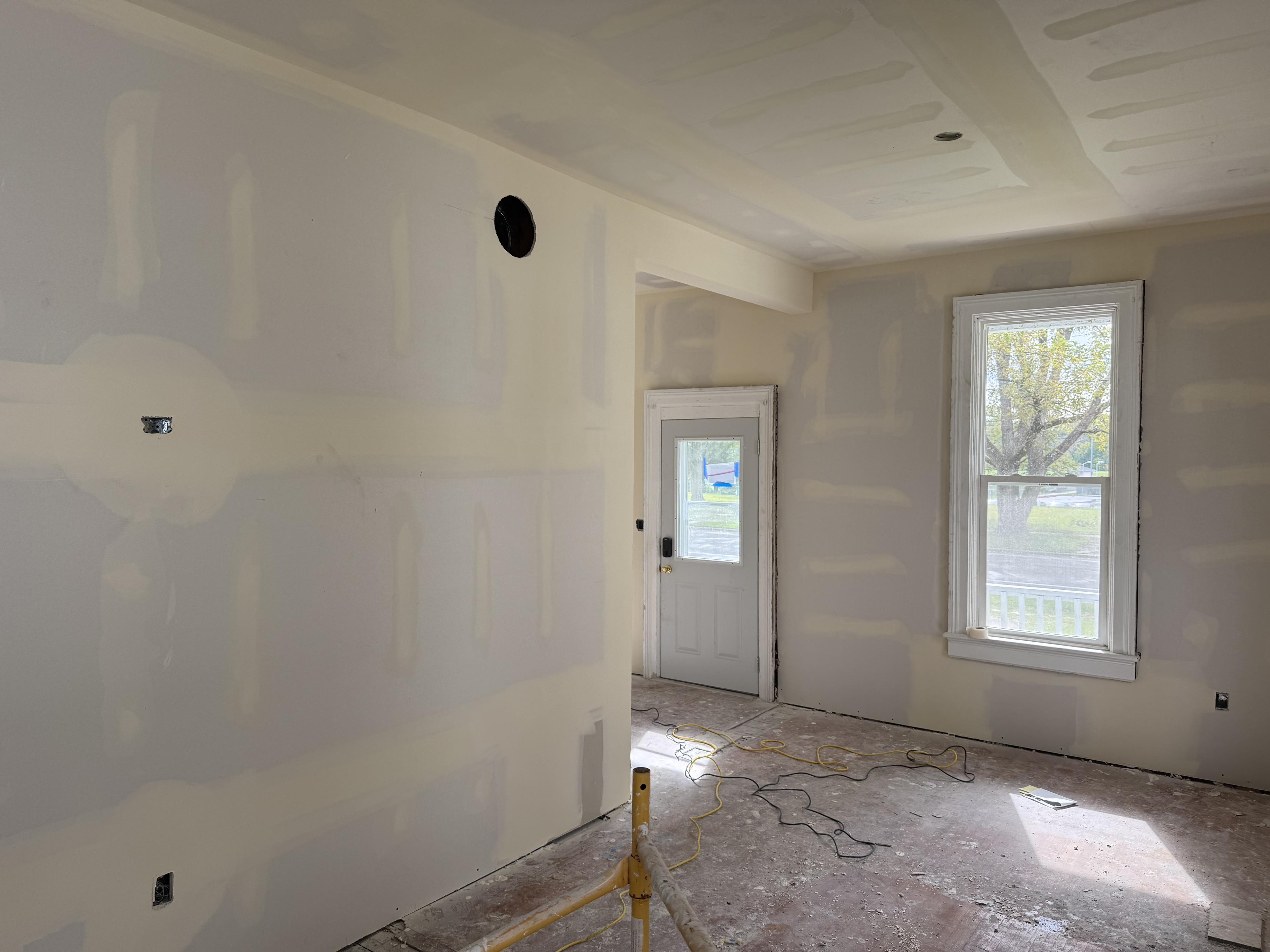 An open room with a door and window.