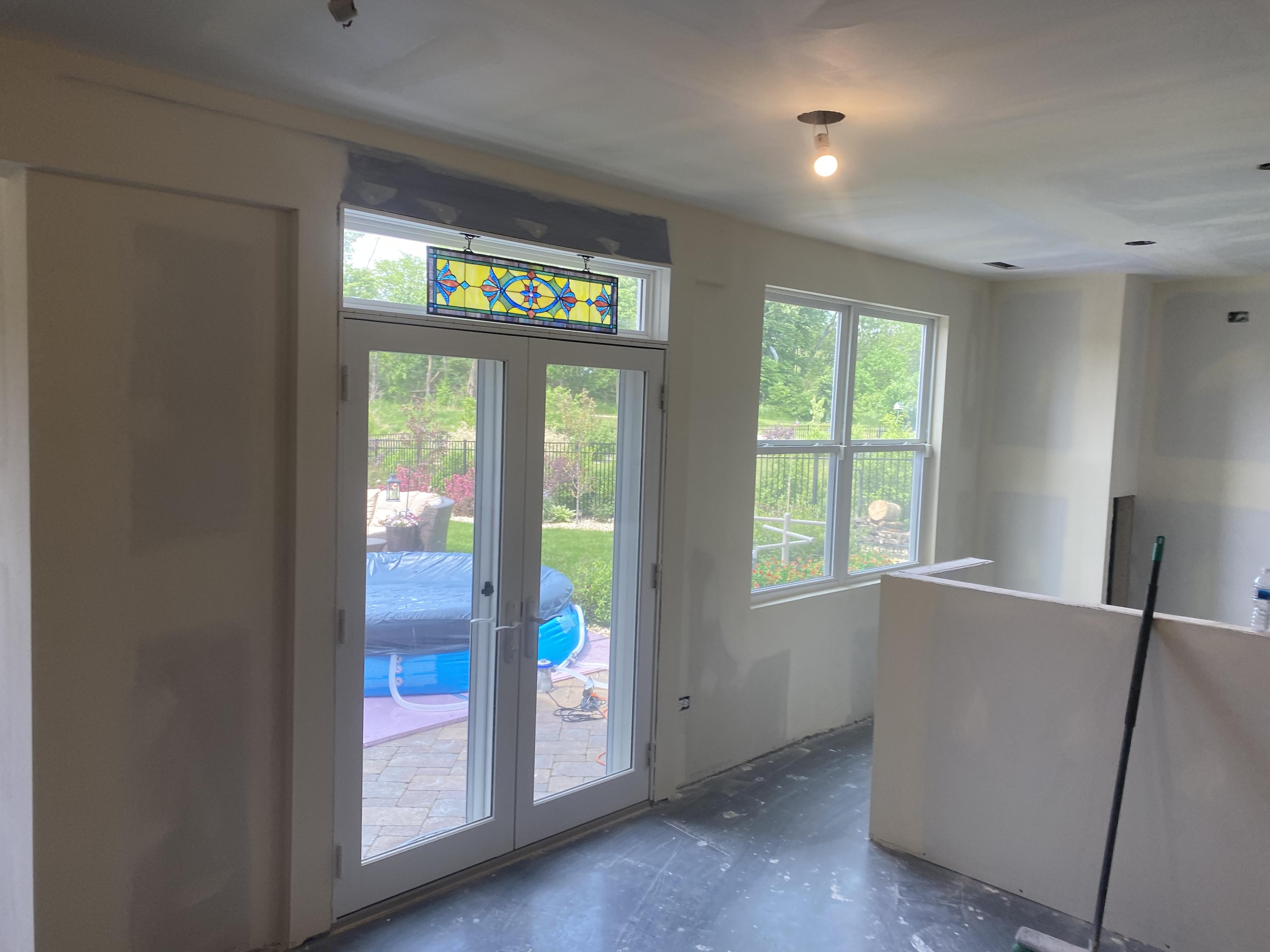 The inside of a house with a half-wall, after drywall work.